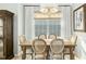 Bright dining room with a wooden table and chairs, large windows, and elegant chandelier at 248 Sweet Bay Pl, Carrboro, NC 27510