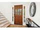 Inviting entryway features a wood door with sidelights, hardwood floors, and a decorative mirror at 248 Sweet Bay Pl, Carrboro, NC 27510