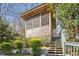 Rustic screened-in structure with steps leading up and green landscaping at 248 Sweet Bay Pl, Carrboro, NC 27510