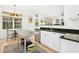 Bright kitchen with white cabinets, stainless steel island, and a breakfast nook at 248 Sweet Bay Pl, Carrboro, NC 27510