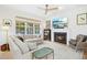 Cozy living room features a fireplace, plush sofa, and large windows with backyard views at 248 Sweet Bay Pl, Carrboro, NC 27510