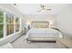 Bright main bedroom with a ceiling fan, plush carpet, and large windows at 248 Sweet Bay Pl, Carrboro, NC 27510