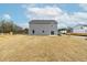 View of back exterior featuring a gray vinyl siding and large open lot at 265 Day Farm Dr, Lillington, NC 27546