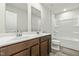 Bathroom features a double sink vanity, modern fixtures, a shower-tub combo, and vinyl floors at 265 Day Farm Dr, Lillington, NC 27546