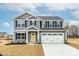 Charming two-story home with gray siding, black shutters, and a two-car garage at 265 Day Farm Dr, Lillington, NC 27546