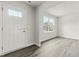 Foyer features hard surface floors and a classic white door with side-lights and double windows at 265 Day Farm Dr, Lillington, NC 27546