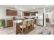 Modern kitchen features stainless steel appliances, an island and wood cabinetry at 265 Day Farm Dr, Lillington, NC 27546