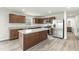 Modern kitchen features stainless steel appliances, an island and wood cabinetry at 265 Day Farm Dr, Lillington, NC 27546