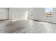 Bright open living area featuring hard surface floors, a front door, and natural light from the double windows at 265 Day Farm Dr, Lillington, NC 27546