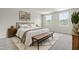 Spacious main bedroom featuring a stylish rug, a wood bench, neutral paint, and bright natural light at 265 Day Farm Dr, Lillington, NC 27546