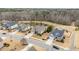 Aerial view of a neighborhood showcasing well-maintained homes, green spaces, and a serene pond at 2675 Beckwith Rd, Apex, NC 27523
