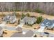 Aerial view of homes in a neighborhood with a pond surrounded by trees at 2675 Beckwith Rd, Apex, NC 27523