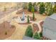 Aerial view highlighting lush backyard with patio, firepit, and manicured landscaping for serene outdoor enjoyment at 2675 Beckwith Rd, Apex, NC 27523