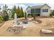 Landscaped backyard featuring a fire pit, patio, and lush greenery, creating a relaxing outdoor space at 2675 Beckwith Rd, Apex, NC 27523