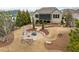 Backyard with stone patio, firepit, and landscaped lawn area with beautiful greenery and privacy at 2675 Beckwith Rd, Apex, NC 27523