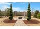 Landscaped backyard with a patio and lush landscaping in a private setting at 2675 Beckwith Rd, Apex, NC 27523