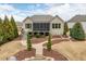 Beautifully landscaped backyard with a screened porch and brick walkway, perfect for outdoor entertaining at 2675 Beckwith Rd, Apex, NC 27523