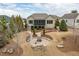 Backyard with stone patio, firepit, and landscaped lawn area with beautiful greenery and privacy at 2675 Beckwith Rd, Apex, NC 27523