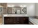 Bathroom with double sinks, a granite countertop, dark cabinetry and tile flooring at 2675 Beckwith Rd, Apex, NC 27523