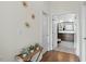 Hallway entrance to bathroom with hardwood floors and decorative gold artwork on the walls at 2675 Beckwith Rd, Apex, NC 27523