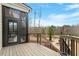 Spacious deck with views of lush landscaping and hardscaped patio below at 2675 Beckwith Rd, Apex, NC 27523