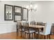 Dining room with hardwood floors, a decorative mirror display, and seating for six at 2675 Beckwith Rd, Apex, NC 27523