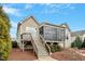 Inviting home exterior with a screened-in porch, deck, and landscaped backyard with stone walkway at 2675 Beckwith Rd, Apex, NC 27523