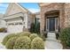 Charming front exterior with stone archway, well maintained landscaping, and two car garage at 2675 Beckwith Rd, Apex, NC 27523