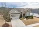 Charming single-story home with a stone facade, a two-car garage, and manicured landscaping at 2675 Beckwith Rd, Apex, NC 27523