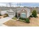 Well-manicured home with stone accents, mature landscaping, and attached two car garage at 2675 Beckwith Rd, Apex, NC 27523