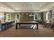 Inviting game room with a pool table, stylish seating, and elegant lighting fixtures at 2675 Beckwith Rd, Apex, NC 27523