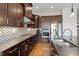 Elegant kitchen featuring dark cabinets, stainless steel appliances, and sleek countertops at 2675 Beckwith Rd, Apex, NC 27523