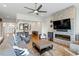 Open concept living area featuring a stone fireplace, hardwood floors, and views into the dining room at 2675 Beckwith Rd, Apex, NC 27523