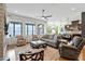 Open living area with hardwood floors, an abundance of natural light, and a view of the kitchen at 2675 Beckwith Rd, Apex, NC 27523