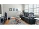 Cozy living room features wood flooring, a large window, and comfortable seating at 2675 Beckwith Rd, Apex, NC 27523