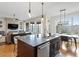 Open concept kitchen, living room and dining area with island and lots of natural light at 2675 Beckwith Rd, Apex, NC 27523