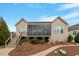 Back exterior view featuring screened in porch, stone walkway, and lush landscaping at 2675 Beckwith Rd, Apex, NC 27523