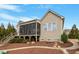 Inviting back exterior showcasing the stone walkway, screened porch, and manicured lawn at 2675 Beckwith Rd, Apex, NC 27523