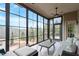 Bright sunroom with floor-to-ceiling windows offering picturesque views of the landscaped yard at 2675 Beckwith Rd, Apex, NC 27523