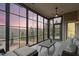 Bright sunroom with floor-to-ceiling windows offering picturesque views of the landscaped yard at 2675 Beckwith Rd, Apex, NC 27523