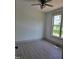 Bedroom showcasing a ceiling fan and large window offering outdoor views; durable flooring throughout at 2833 Faucette Ln, Burlington, NC 27217