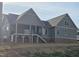 New home featuring a covered back porch with stairs leading to the yard at 2833 Faucette Ln, Burlington, NC 27217