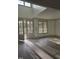 Bright living room with lots of light through the large windows, and a light wood floor at 2833 Faucette Ln, Burlington, NC 27217