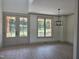 Bright living room featuring stylish light fixture, with views to a porch and large windows at 2833 Faucette Ln, Burlington, NC 27217