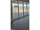 Sliding glass doors leading to the patio with a serene outdoor view of the surrounding landscape at 2833 Faucette Ln, Burlington, NC 27217