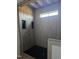 New shower with gray vertical tiling, black honeycomb floor, and built-in shower storage at 2833 Faucette Ln, Burlington, NC 27217