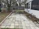 Backyard patio area with stone pavers, offering a relaxing space for outdoor seating and entertaining at 300 W Carr St, Mebane, NC 27302