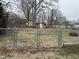 Fenced backyard featuring a large grassy area, offering privacy and space for outdoor activities at 300 W Carr St, Mebane, NC 27302