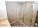 Bathroom with a walk-in shower featuring glass doors and tile flooring at 300 W Carr St, Mebane, NC 27302