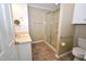 Bathroom featuring a glass shower, updated sink and vanity at 300 W Carr St, Mebane, NC 27302